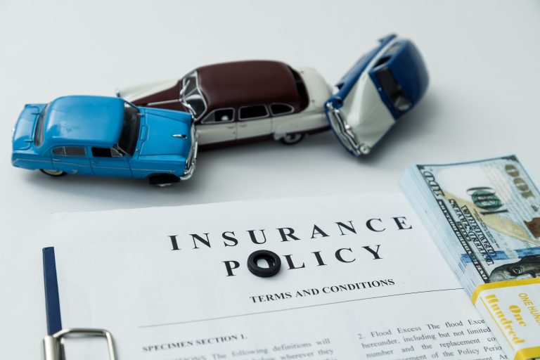 Car accident scene with insurance documents representing the auto insurance claims process