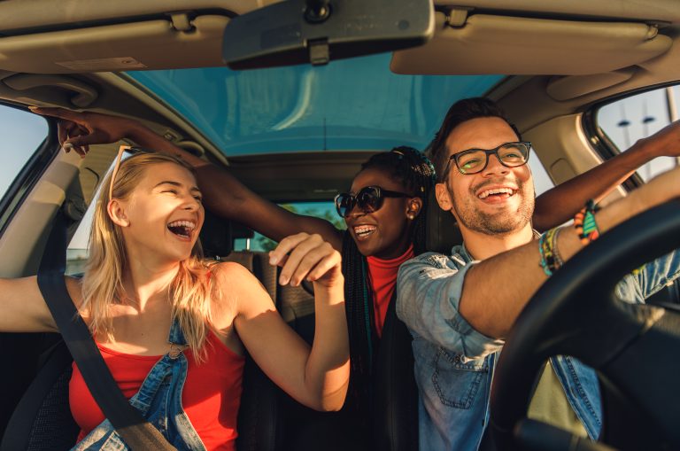 Teen driver and family riding safely in a car, representing young driver insurance tips