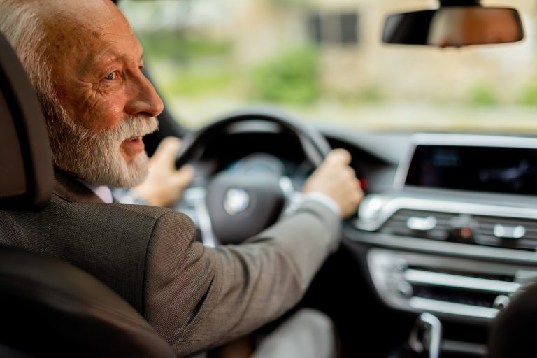 Senior driver safely driving a vehicle, representing insurance tips for mature drivers