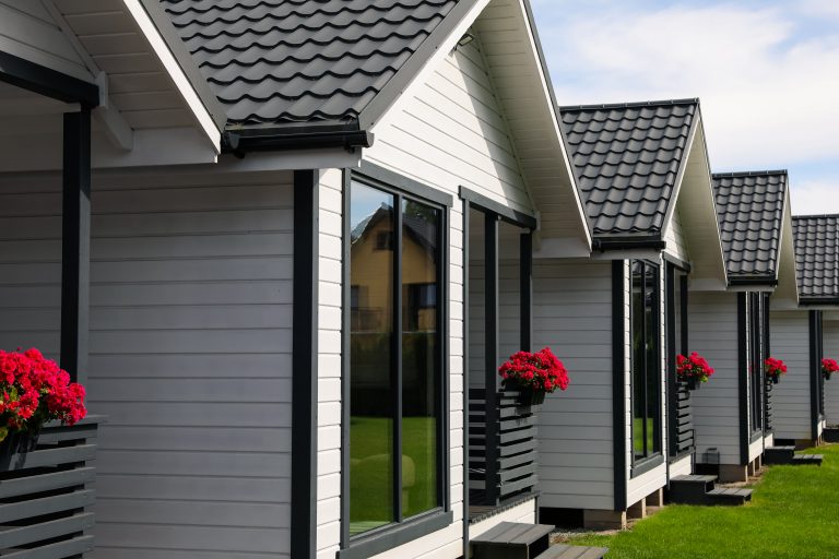 Modern modular homes with white exteriors and green lawns