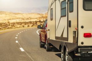 Travel trailer being towed by a pickup truck on a scenic Utah road